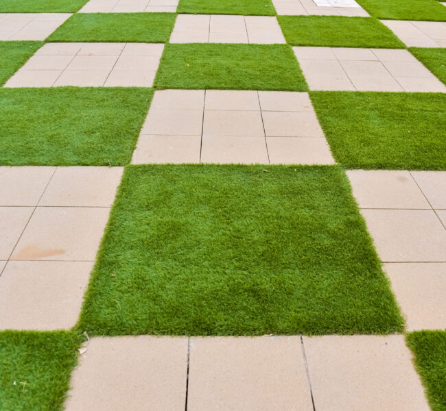 Real background of some tiles with grass in the form of a chessboard. Real background of some tiles with grass in the form of a chessboard.
